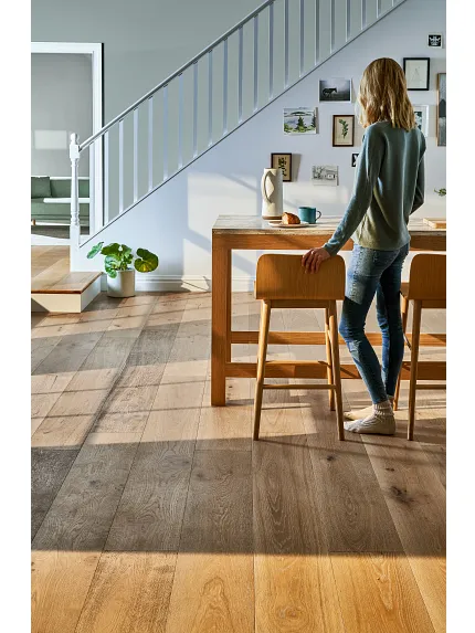 woman standing at a table in a living room area